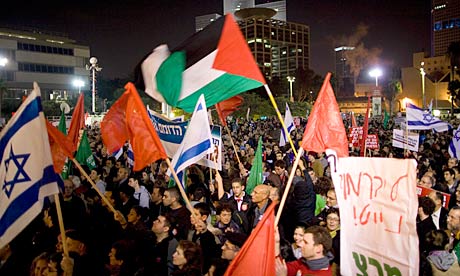 Israeli and Palestinian flags are waved by thousands of activists from leftwing groups in Tel Aviv
