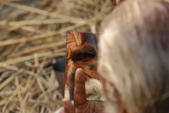 24 hours in pics: A Hindu pilgrim makes a sacred sign on his forehead