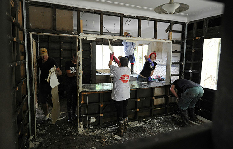 24 hours in pics:  Local residents and volunteers work on flood damaged interior, Australia
