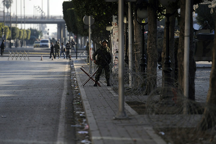Tunisia: Soldiers stand guard on a street of Tunis
