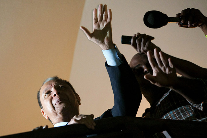 Baby Doc Duvalier returns: Duvalier waves from the balcony of his hotel