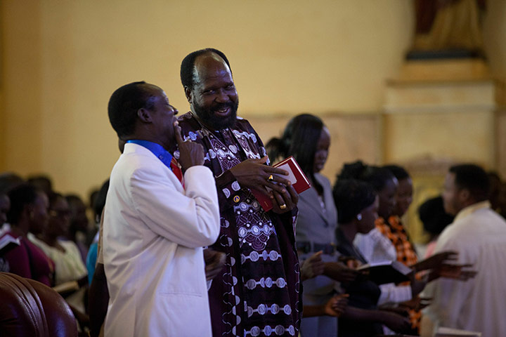 Sudan election: President Salva Kiir, second left, smiles at the end of Sunday mass in Juba