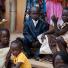 Sudan election: Children wear their Sunday best as they sit outside a church
