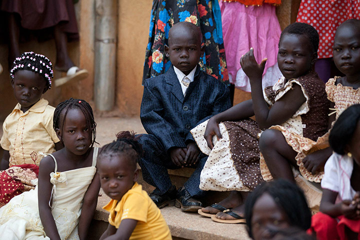 Sudan election: Children wear their Sunday best as they sit outside a church