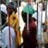 Sudan election: Christian women look at crucifixes for sale outside a local church