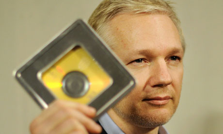 Julian Assange holds a CD containing data