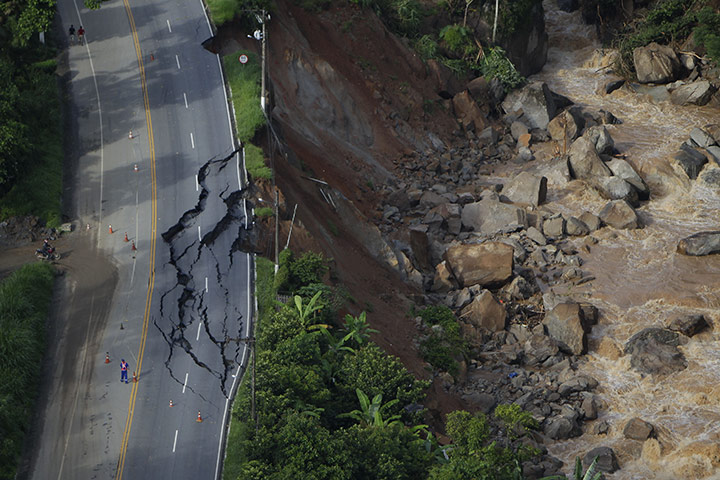 Felipe Dana in Brazil: A worker stands at a blocked road after landslides in Nova Friburgo, Brazil