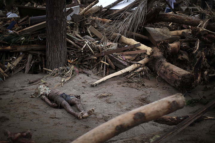 Felipe Dana in Brazil: A landslide victim lies next to debris in Teresopolis