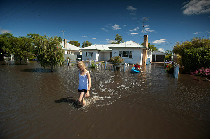 Victoria flood: Children navigate through a flooded street  in Horsham