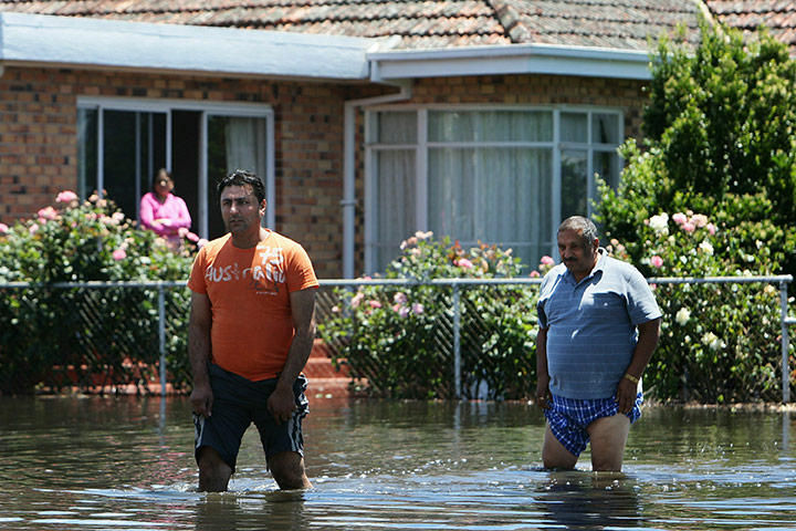 Victoria flood: Residents wade through flood water outside their home