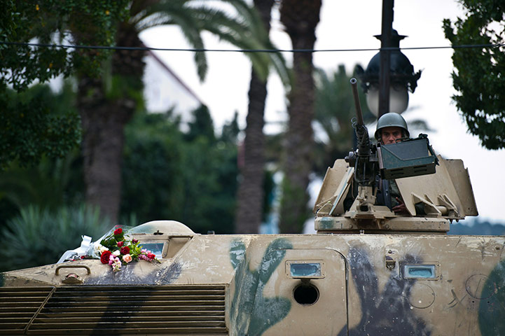 Tunis protest: Flowers are displayed on a Tunisian army tank