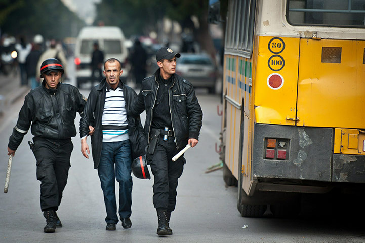 Tunis protest: A protester is arrested by policemen in Tunis