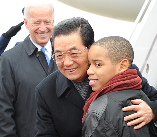 Hu Jintao in Washington: Chinese President Hu Jintao hugs a boy greeting him at Washington
