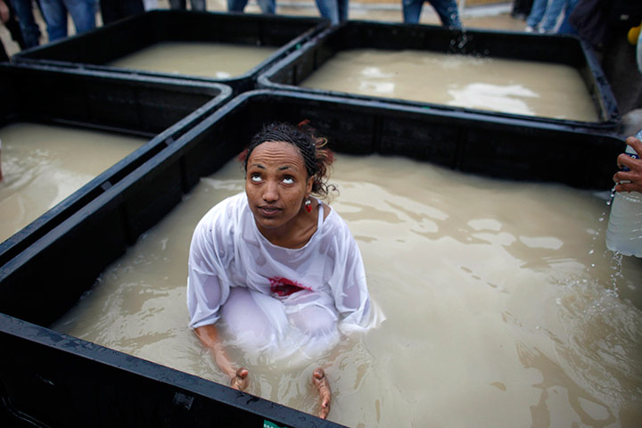 Orthodox epiphany: A Christian pilgrim in water from the Jordan River