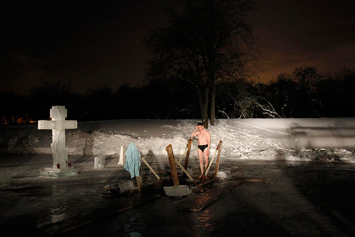 Orthodox epiphany: A man crosses himself before he dips into icy waters in Moscow