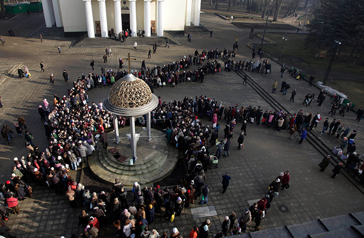 Orthodox epiphany: Worshipers line up to fill vessels with water at main cathedral,  Moldova
