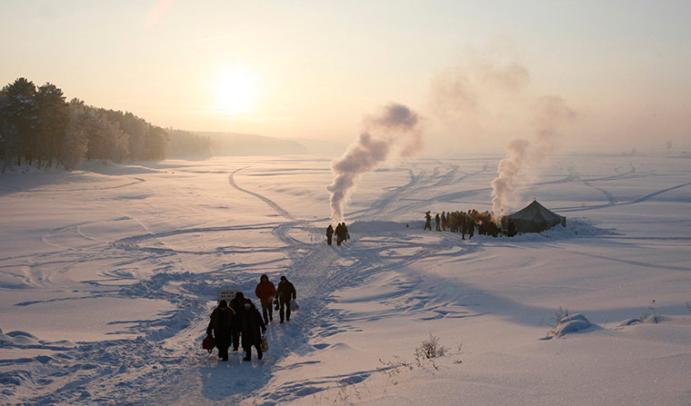 Orthodox epiphany: People stand around an ice hole on the Buzim Lake during Orthodox Epiphany