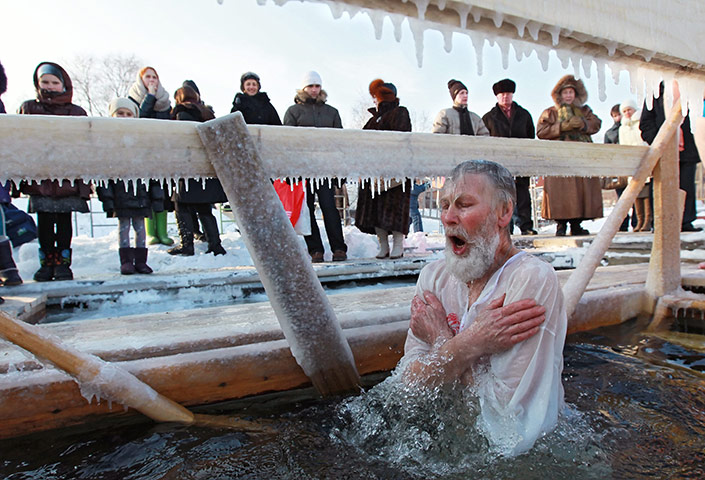 Orthodox epiphany: Russian man prays as he dives into the icy water of the Moskva River