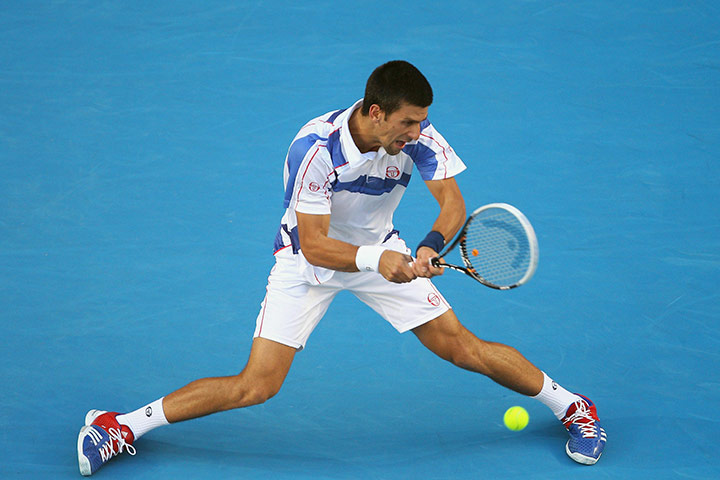 Australian Open Day 3: Novak Djokovic plays a backhand return to Ivan Dodig