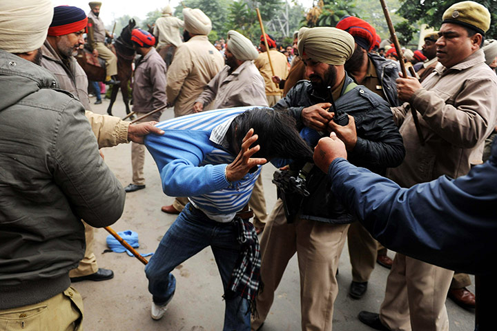 24 hours in pictures: Indian police officers clash with protesters
