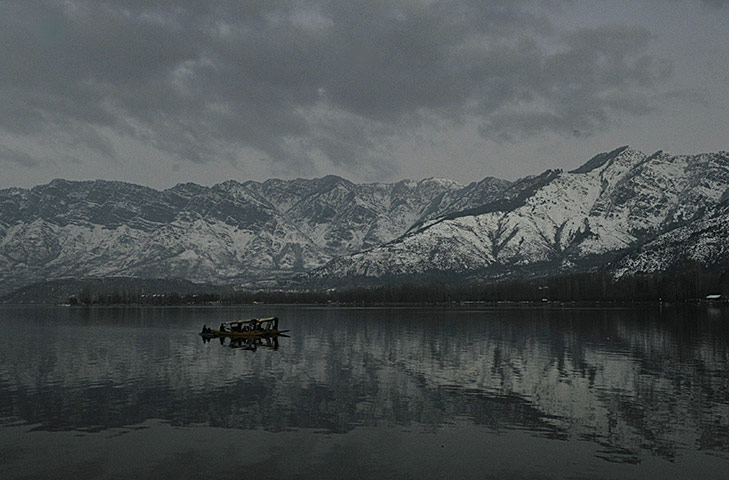 24 hours in pictures: A boat passes in Kashmir