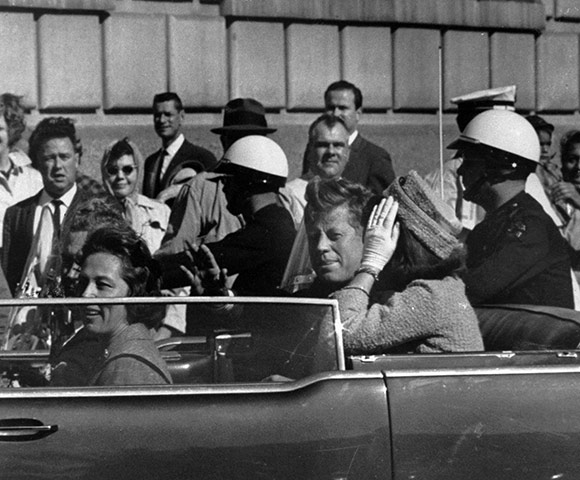 JFK Anniversary: President John F Kennedy rides in a motorcade with his wife Jacqueline