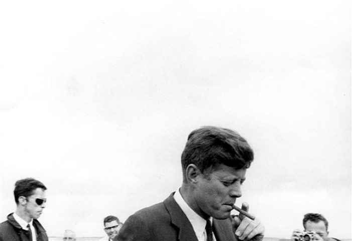 JFK Anniversary: John Kennedy arrives in Hyannis Port, Mass. puffing on a cigar May