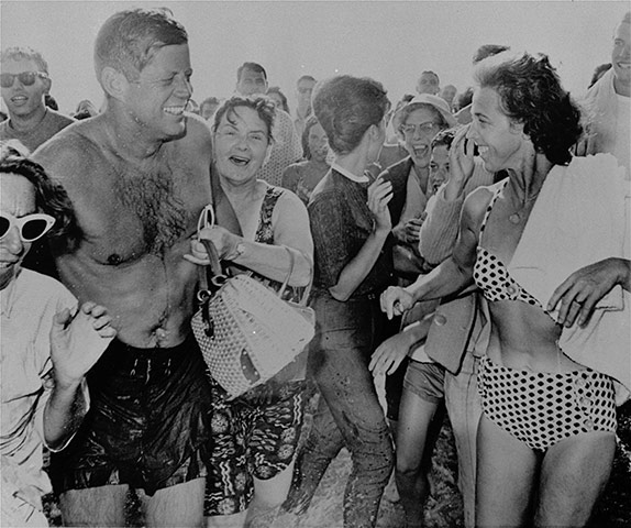 JFK Anniversary: John F. Kennedy smiles surrounded by fans after going for a swim