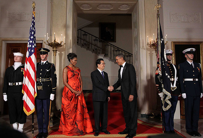 Hu Jintao in Washington: Barack Obama shakes hands with Hu Jintao as Michelle Obama looks on