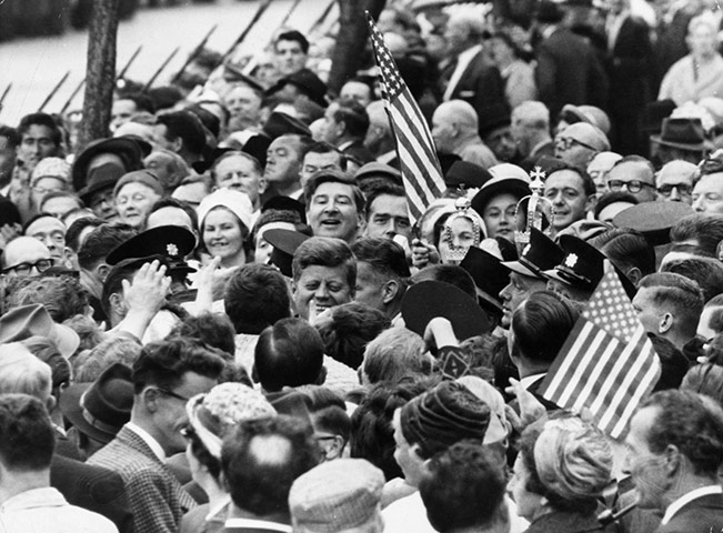 JFK Anniversary: John F Kennedy is almost lost among a crowd of well-wishers