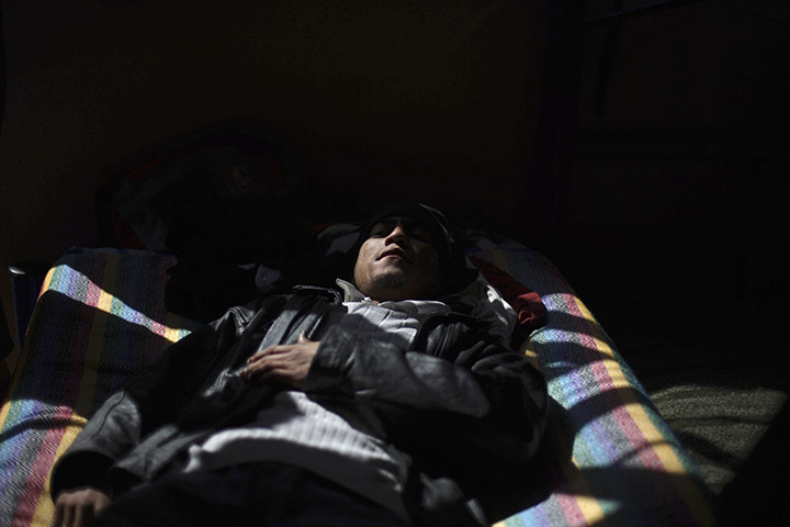 24 hours in pictures: A migrant rests  in Tultitlan, Mexico
