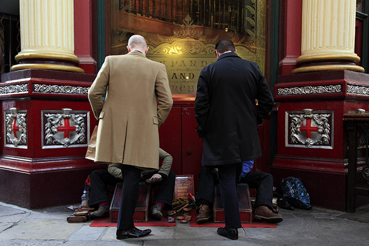 Week in business: Men have their shoes cleaned in central London