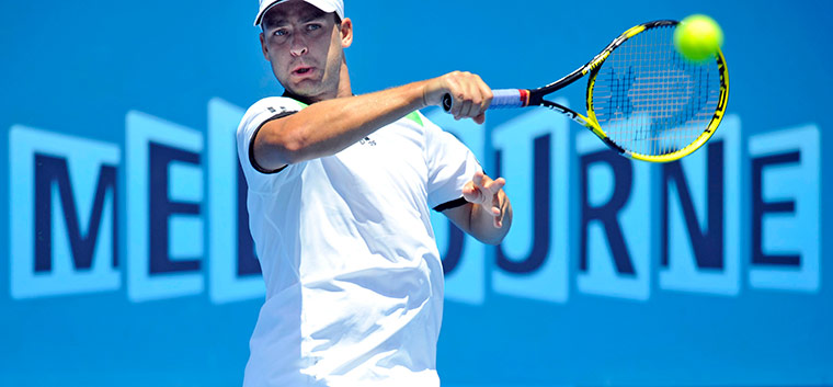 Melbourne Tennis Day 4: Mikhail Youzhny of Russia returns the ball against Blaz Kavcic