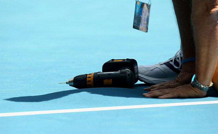 Australian Open Day 6: Workman repair the court on the Hisense Arena