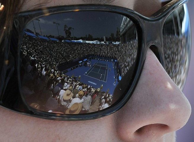 Australian Open Day 6: The court is reflected in the sunglasses of a spectator