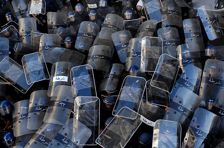 24 hours in pictures: Algiers, Algeria: Riot policemen use their shields during a demonstration