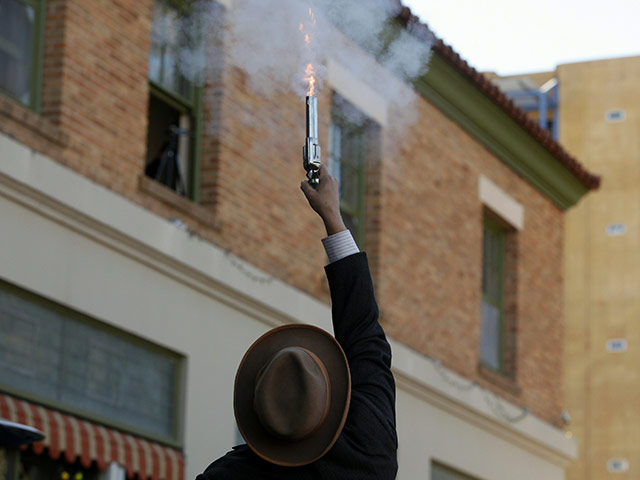 24 hours in pictures: Tucson, Arizona, USA:  An actor fires a pistol during a re-enactment