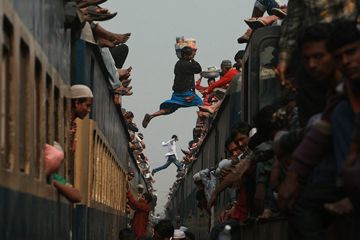 24 hours in pictures: Tongi, Bangladesh: A vendor and a man jump from an overcrowded train