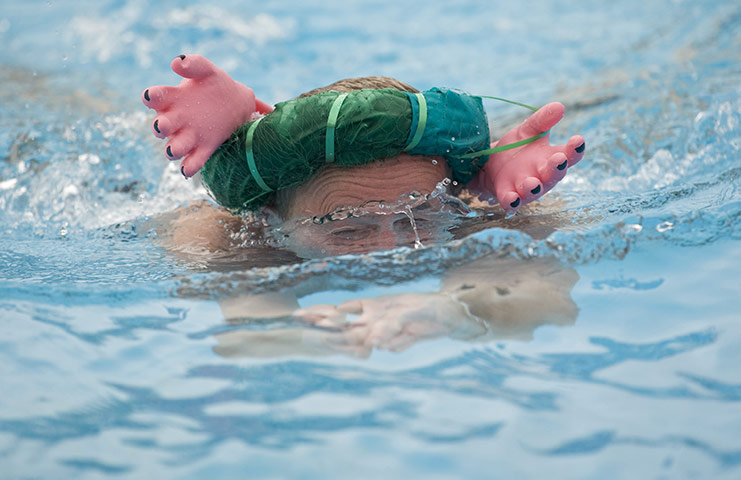 Cold water swimming: A swimmer in the Heads up breaststroke wearing an eccentric hat