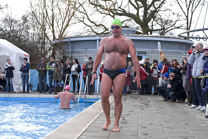 Cold water swimming: A swimmer emerges very red after taking part in the endurance race