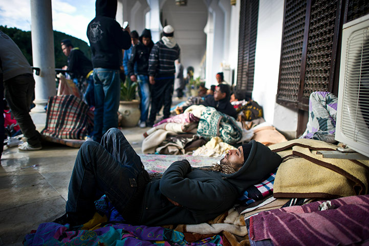 Tunisia Protests: A protester sleeps outside Prime Minister's office in Tunis