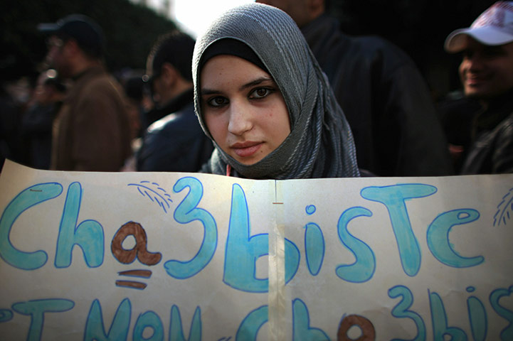 Tunisia Protests: A young female protester takes part in demonstrations