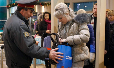 Police at Moscow's Domodedovo airport check the hand luggage of passengers after bomb attack 