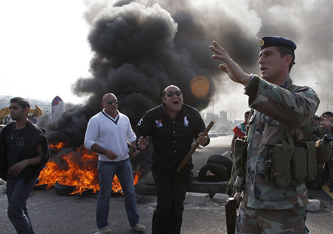 Lebanon Protests: A Lebanese Sunni Muslim supporter carries a stick