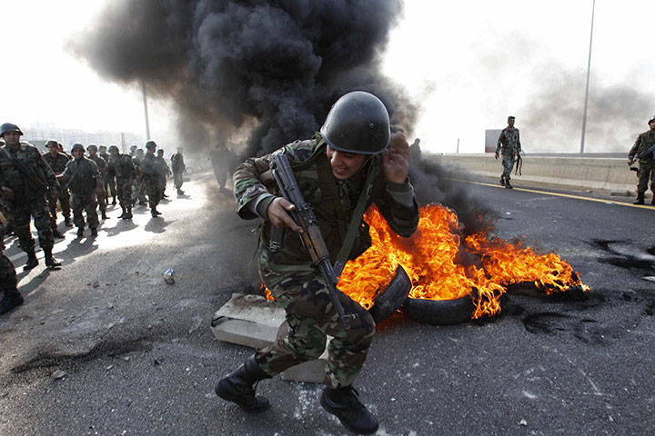 Lebanon Protests: Lebanese soldier runs past burning tires in Sidon