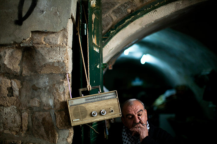 24 hours in pics: A Palestinian man listens to the radio in Jerusalem old city