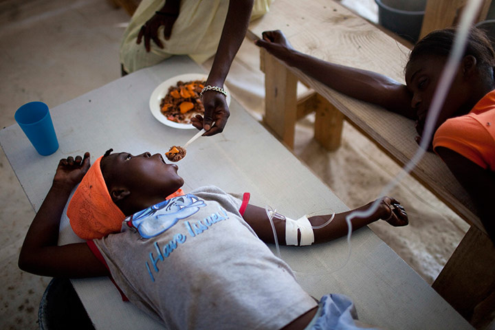 24 hours in pics: Janika Faneus is fed by her mother while receiving treatment for cholera