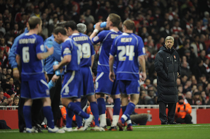 Arsenal v Ipswich Town: Arsene Wenger looks on as the Ipswich players have a drink
