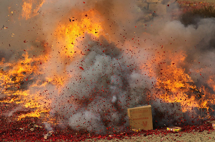 24 hours in pictures: policemen destroy illegal fireworks in qingdao