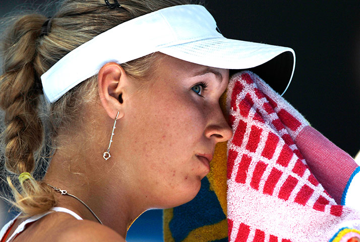 Melbourne Day 11: Denmark's Caroline Wozniacki wipes sweat from her face